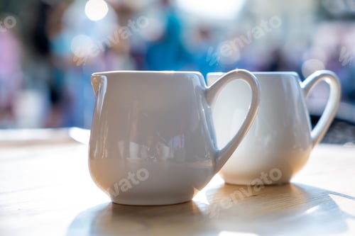 Preview: Two white cups of coffee on a table of outdoor cafe
