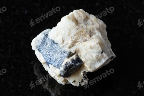 Preview: blue corundum sapphire in rough rock on black