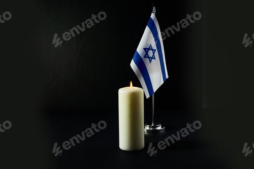 Preview: Flag of Israel, barbed wire and burning candle on black background. Holocaust memory day