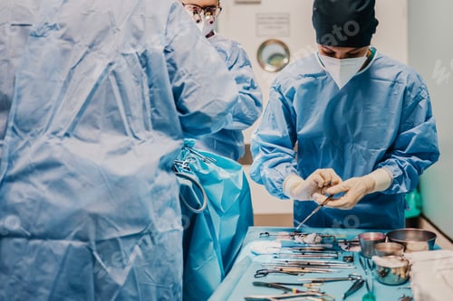Preview: Female nurse assistant preparing tools for surgery inside operation room at hospital