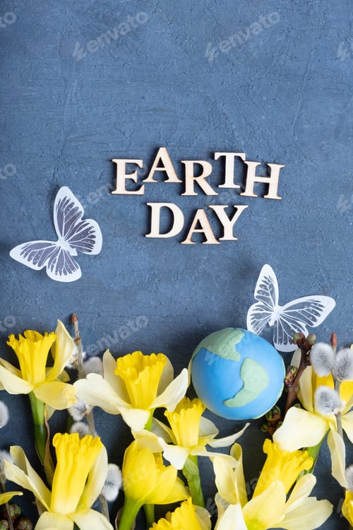Preview: Earth day text with globe, flowers and butterfly. Happy Earth day concept flat lay, top view
