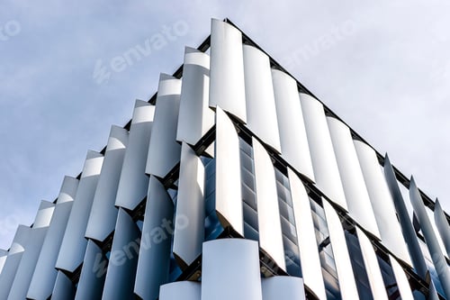 Preview: The facade of a modern building with an innovative facade made of automatic, movable blinds.