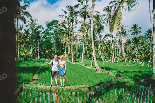 Preview: Carefree couple taking photo in tropical forest
