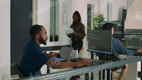 Preview: African american developer using laptop to write code and display system information