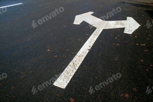 Preview: white directional arrow in parking lot