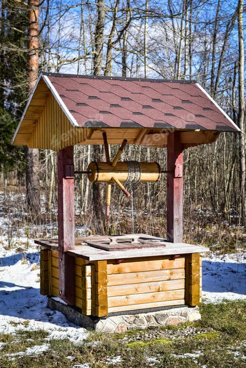 Preview: New modern well with a wooden roof farmhouse yard.