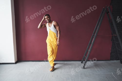Preview: Spacey room. Young african american worker in the yellow uniform have some job