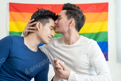 Preview: Portrait of Asian handsome man gay family holding LGBT flag and smile.
