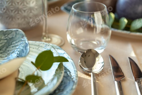Preview: Silver cutlery on table top with tablecloth