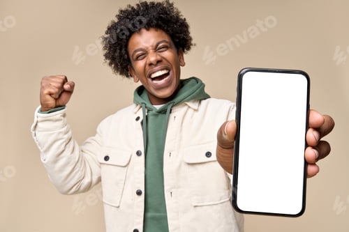 Preview: Happy African American winner showing big mock up mobile phone screen.