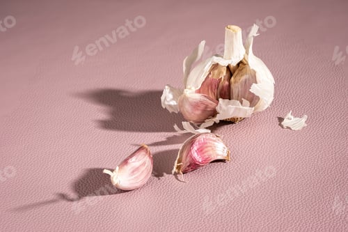 Preview: Purple garlic bulb and cloves on pink background