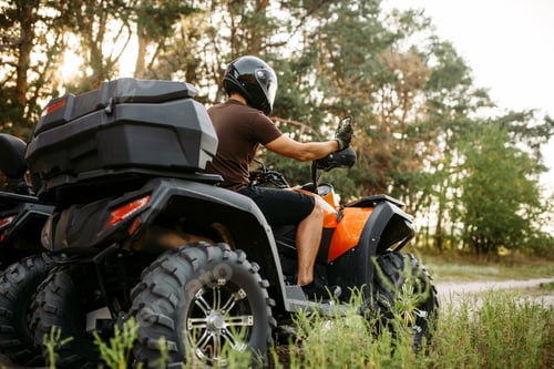 Preview: Rider in helmet on quad bike, front view, closeup