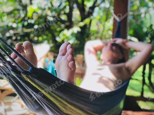 Relaxing in a Hammock Outdoors among Greenery