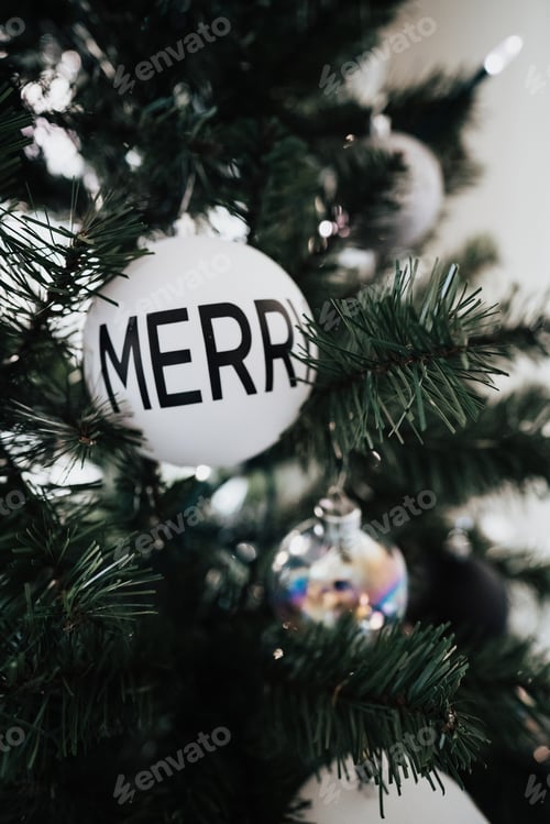 Preview: Merry Christmas bulb ornament on Christmas tree with lights