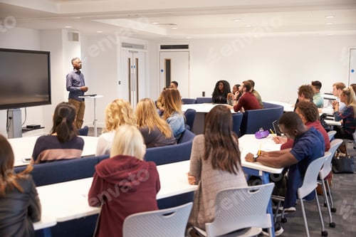 Preview: University students study in a classroom with male lecturer