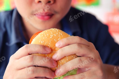 Preview: Beef Hamburger Eating On A Man Hand In Close Up