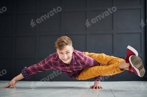 Preview: Young strong man practices yoga at the yoga studio