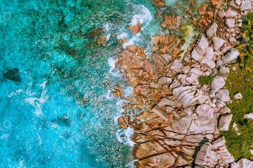 Preview: Aerial view of Seychelles Anse Cocos beach at La Digue Island. Pure crystal clear turquoise ocean