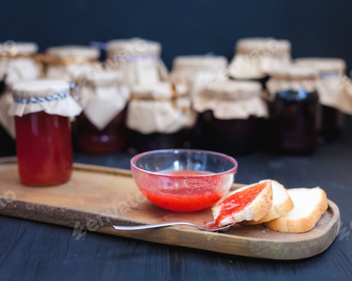 Preview: tea and jar with jam on a wooden tray