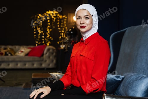 Preview: Muslim woman posing by Christmas decor for New Year