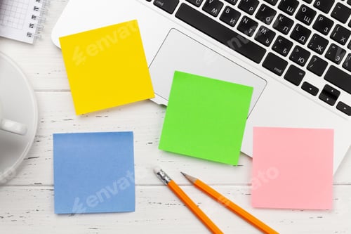 Preview: Office desk with colorful stickers, coffee and laptop