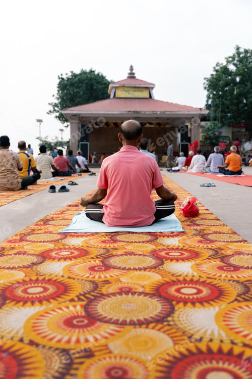 Preview: Indian man praying with lotus position on an outdoor temple