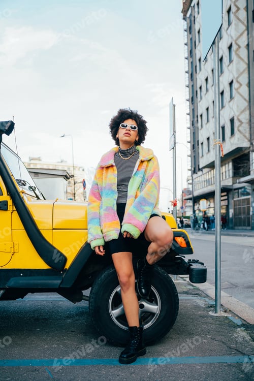 Preview: Stylish confident black curly hair woman posing outdoor