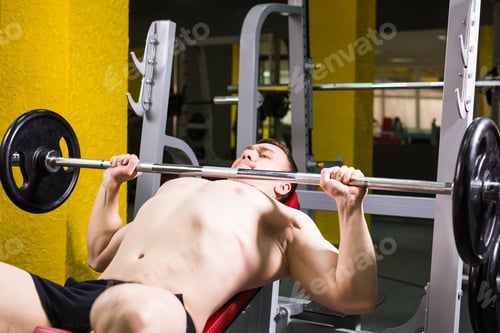 Preview: Strong man running exercise for the chest in the gym. Sport, bodybuilding, gym and people concept