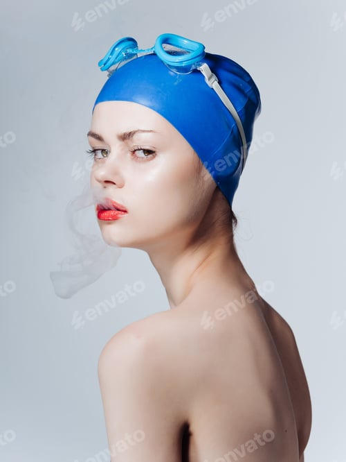 Preview: woman athlete in swimming goggles smokes a cigarette Professional
