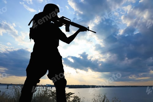 Preview: Soldier with machine gun patrolling outdoors. Military service
