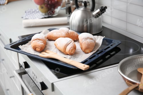 Preview: Baking tray with tasty croissants on stove
