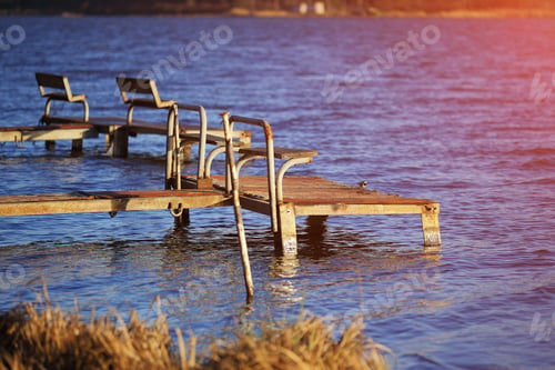 Preview: empty old footbridges with benches on a lake