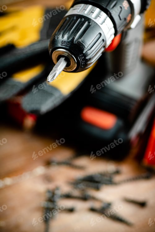 Preview: Cordless Drill and Screws on a Wooden Workbench