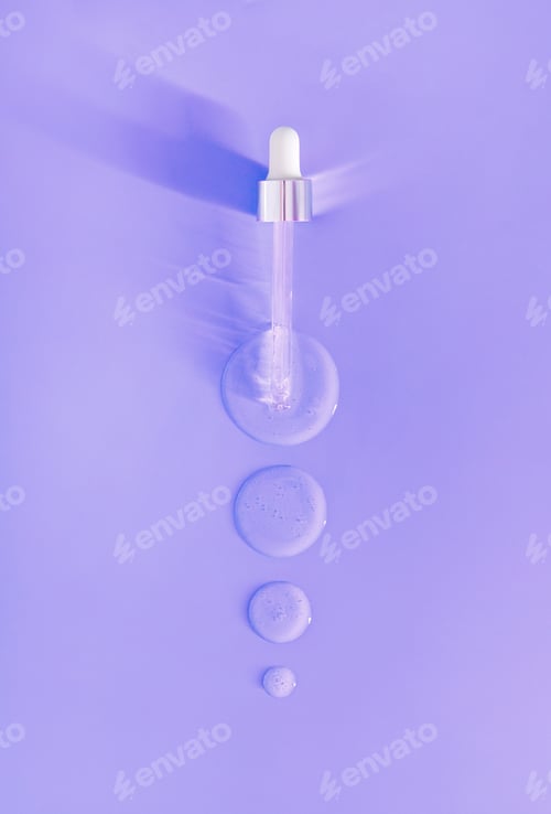 Preview: pipette drops of serum on purple background