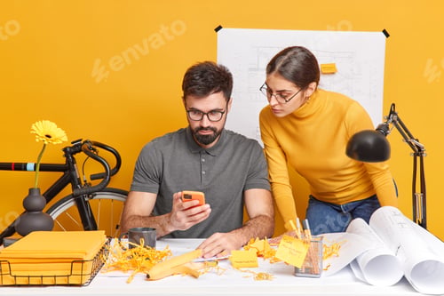 Preview: Partnership and collaboration concept. Busy woman and man designers or engineers work together think