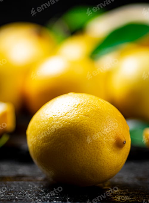 Preview: Fragrant lemons with leaves on the table.