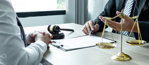 Preview: Lawyers in Meeting at Desk with Legal Contract