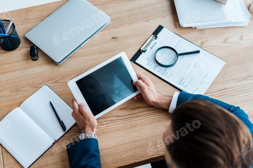 Preview: selective focus of recruiter holding digital tablet with blank screen