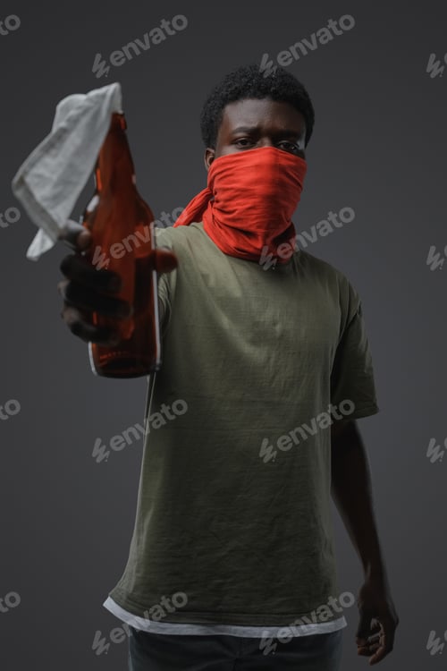 Preview: Rebellious african man with molotov cocktail and bandana