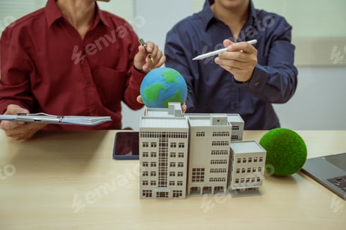 Preview: Two businessmen work at desks office,discussing city clean energy strategies global technology