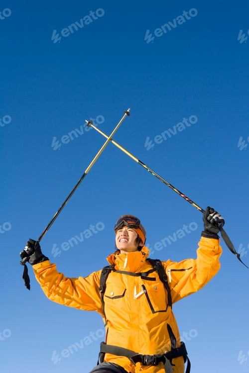 Preview: Young man with his ski poles in the air