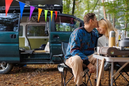 Preview: Camping Bliss: Couple Enjoying Nature's Peace by Their Camper