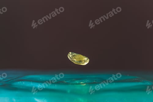 Preview: gold Water droplets fall down closely into the blue water, making it the perfect center in nature