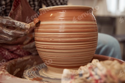 Preview: Potter using modeling wooden tool on soft clay surface