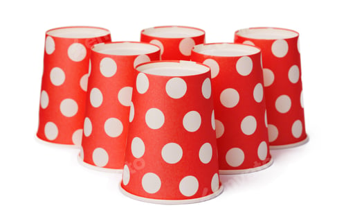 Preview: Group of cardboard disposable red dotted cups isolated