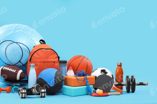 Preview: Many different sports equipment on light blue background, space for text