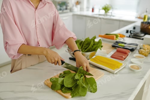 Preview: Woman Cutting Greens For Salad