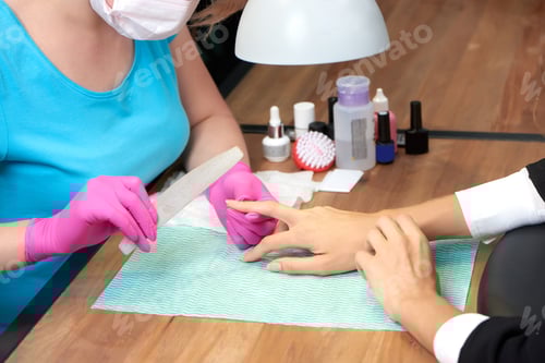 Preview: Manicurist Fills Nails for Client at Beauty Salon