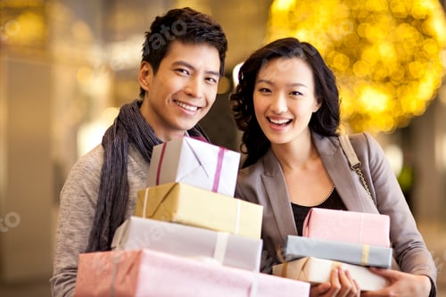 Preview: Happy young couple with gift boxes