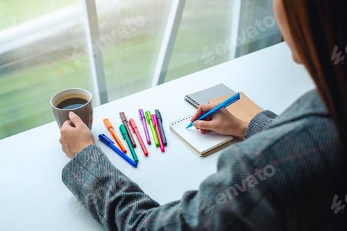 Preview: a woman writing on a blank notebook